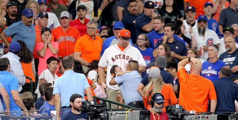May 29, 2019; Houston, TX, USA; A young fan is taken to receive medical attention after being hit by a foul ball by Chicago Cubs center fielder Albert Almora Jr. (5) during the game against the Houston Astros at Minute Maid Park. Mandatory Credit: Erik Wi