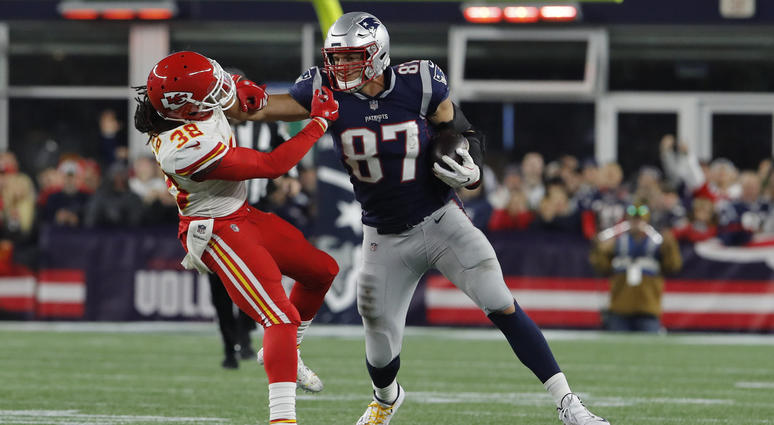 Oct 14, 2018; Foxborough, MA, USA; New England Patriots tight end Rob Gronkowski (87) makes a catch and stiff arms Kansas City Chiefs free safety Ron Parker (38) in the second half at Gillette Stadium. The Patriots defeated Kansas City 43-40. Mandatory Cr