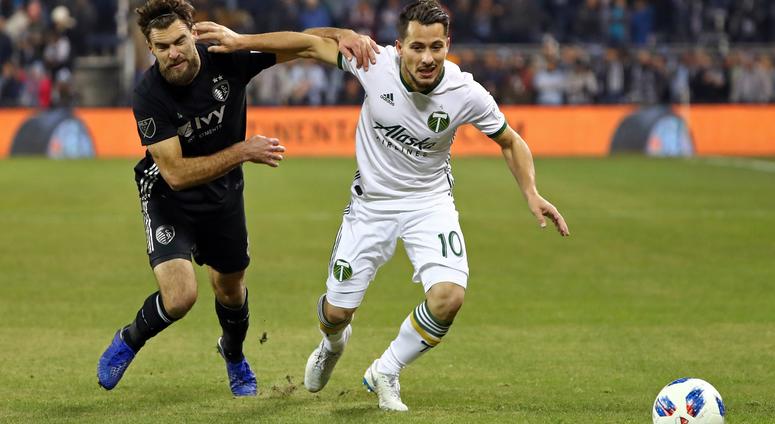 Nov 29, 2018; Kansas City, KS, USA; Portland Timbers midfielder Sebastian Blanco (10) and Sporting Kansas City midfielder Graham Zusi (8) fight for the ball during the first half in the second leg of the MLS Western Conference Championship at Children's M