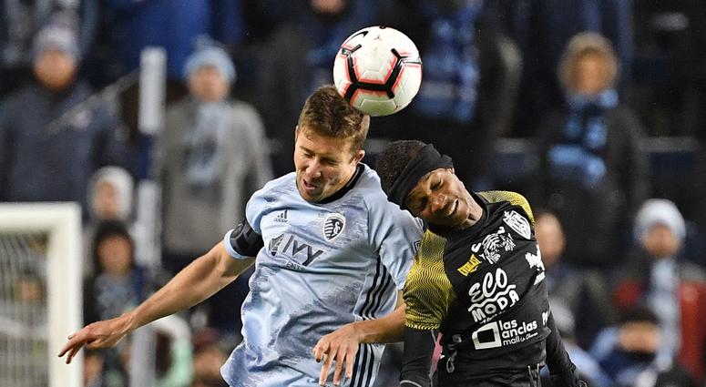 Mar 14, 2019; Kansas City, KS, USA; Sporting Kansas City defender Matt Besler (5) heads the ball against Independiente forward Romeesh Ivey (22) during the second half at Children's Mercy Park.