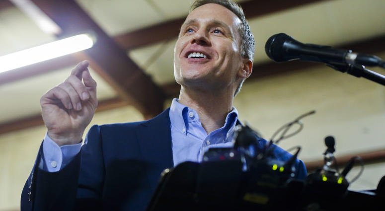 Missouri Gov. Eric Greitens cheers on a crowd after several protestors were removed from the building before a ceremonial signing making Missouri a "right-to-work" state Missouri Gov. Eric Greitens cheers on a crowd after several protestors were removed from the building before a ceremonial signing making Missouri a "right-to-work" state