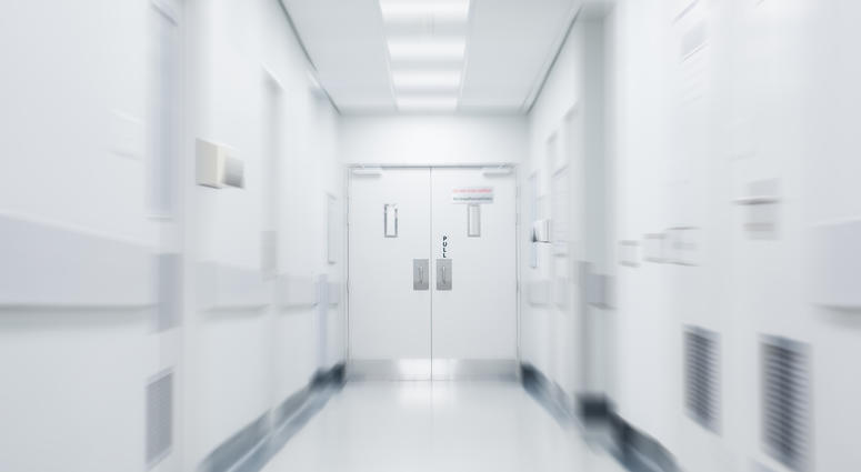 Empty corridor in modern hospital. Empty long hallway in the hospital. Empty clinic hall with white walls.