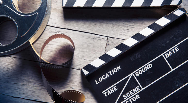 movie, film Movie clapper and film reel on a wooden background