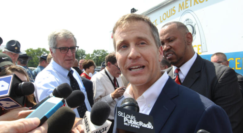 Missouri Governor Eric Greitens talks with reporters after introducing a new program that will deal with the violence problem in St. Louis during a press conference in St. Louis on July 10, 2017.
