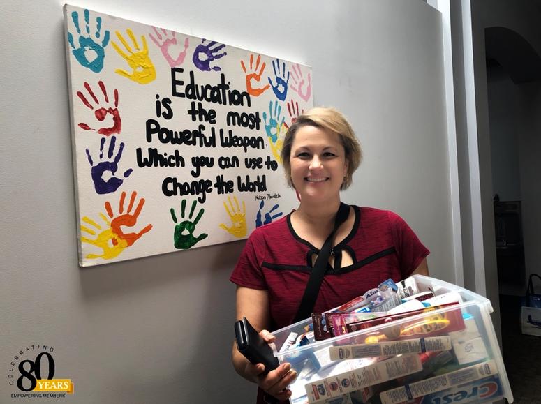 Debbie Monterrey with some donated personal hygiene items for the Little Bit Foundation Little Bit Foundation donation Debbie Monterrey American Eagle Credit Union person hygiene drive