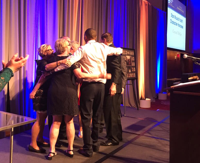 Cornell McKay hugging members of Stan Musial's family. Cornell McKay hugging members of Stan Musial's family.