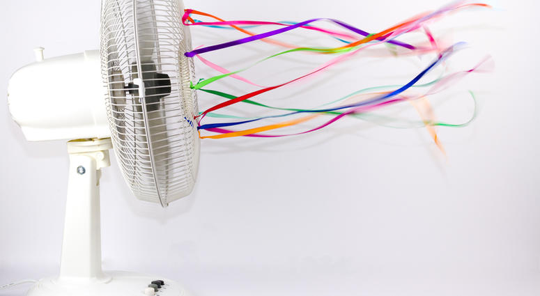fan An electric fan blowing colorful silk ribbons