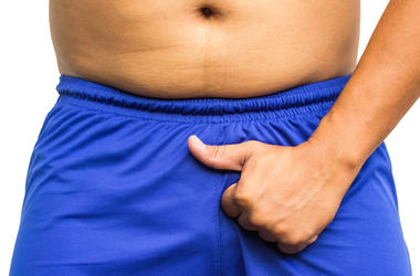 Pornhub Crea El Traje De Baño Contra Erecciones man holding his penis in his shorts, showing thumb up. No problems in the potency