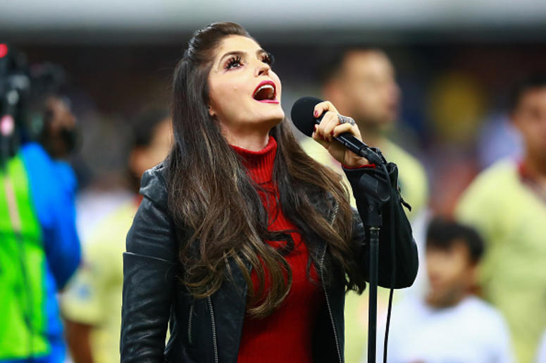 Ana Bárbara Llora En Rueda De Prensa Singer Ana Barbara sings the national anthem of Mexico during the final first leg match between America and Cruz Azul as part of the Torneo Apertura 2018 Liga MX at Azteca Stadium on December 13, 2018 in Mexico City, Mexico.