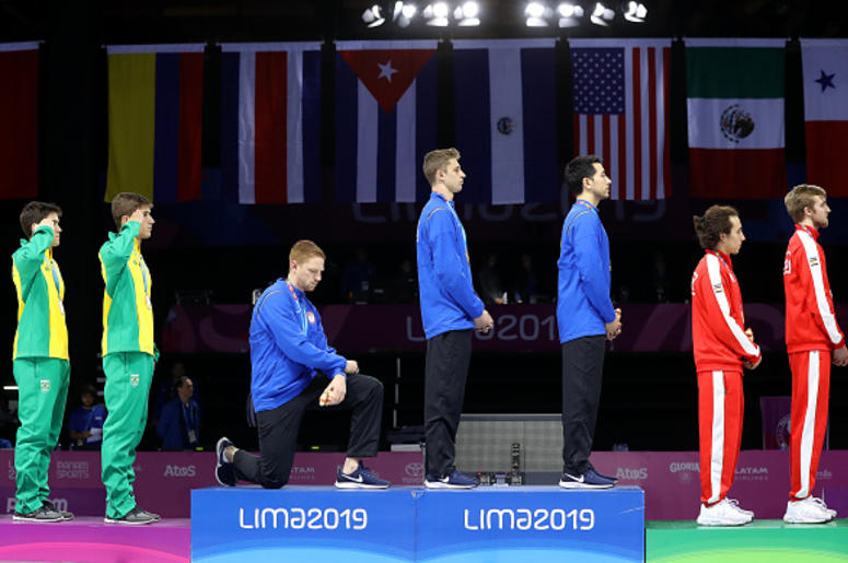 Medallista de Oro Estadounidense Protesta Contra Trump Gold medalist Race Imboden of United States takes a knee during the National Anthem Ceremony in the podium of Fencing Men's Foil Team Gold Medal Match Match on Day 14 of Lima 2019 Pan American Games at Fencing Pavilion of Lima Convention Center on August