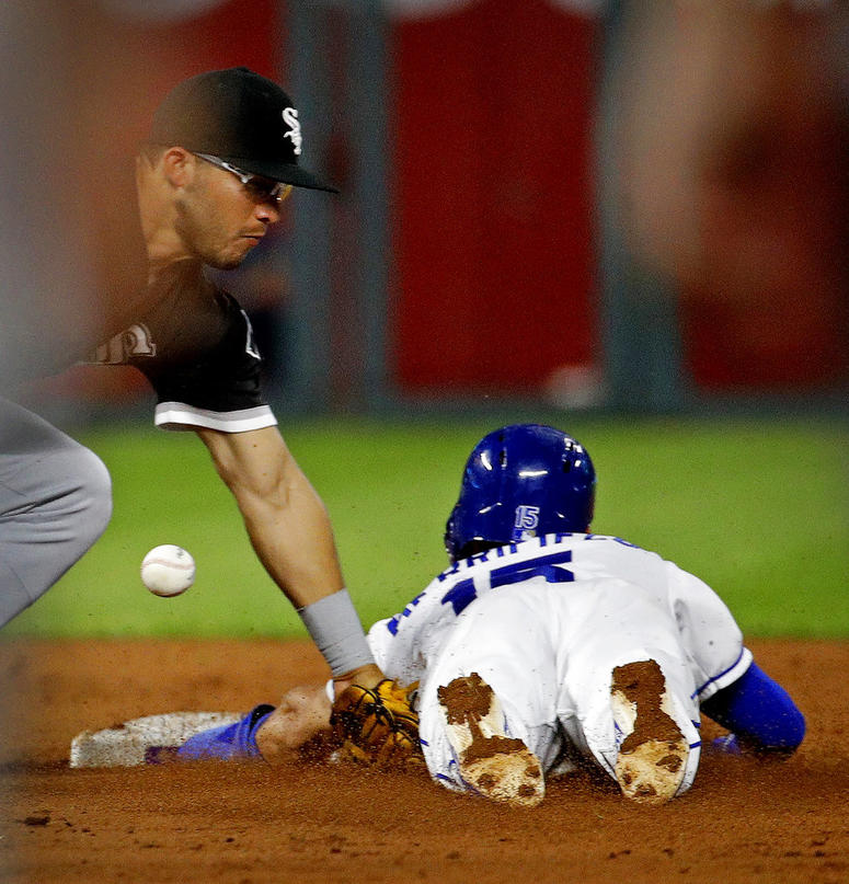 Kansas City Royals' Whit Merrifield (15) beats the stag by Chicago White Sox third baseman Yolmer Sanchez to steal second during the third inning