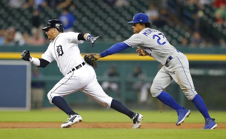Detroit Tigers' Victor Martinez, left, is caught in a rundown by Kansas City Royals second baseman Adalberto Mondesi during the first inning