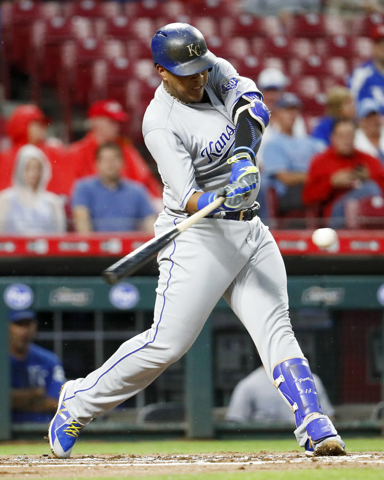 Kansas City Royals' Salvador Perez hits a single off Cincinnati Reds starting pitcher Matt Harvey during the second inning o
