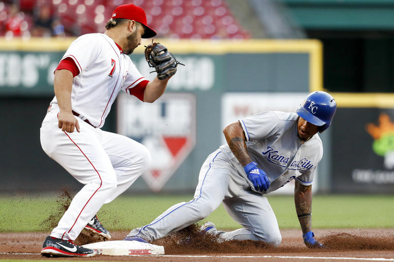 Kansas City Royals' Adalberto Mondesi, right, steals third against Cincinnati Reds third baseman Eugenio Suarez (7) during the first inning of