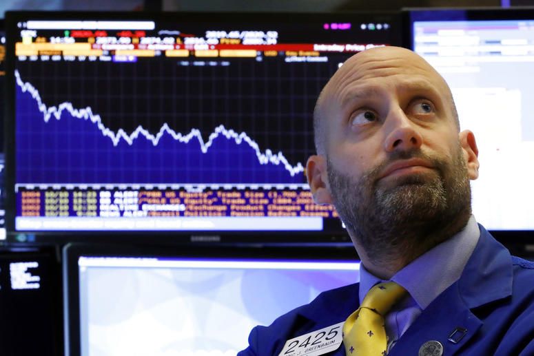 Specialist Meric Greenbaum works at his post on the floor of the New York Stock Exchange