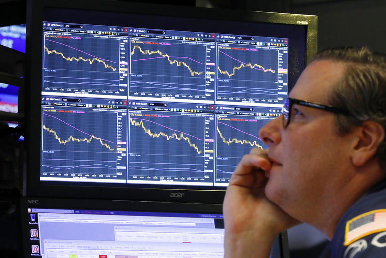 Specialist Gregg Maloney works at his post on the floor of the New York Stock Exchang