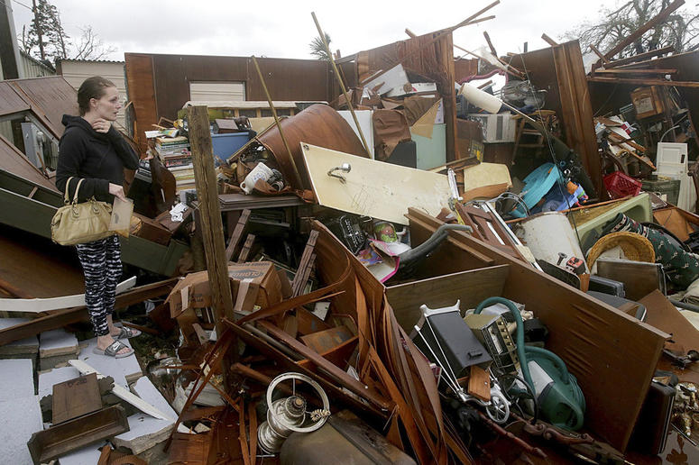 Haley Nelson inspects damages to her family properties in the Panama City