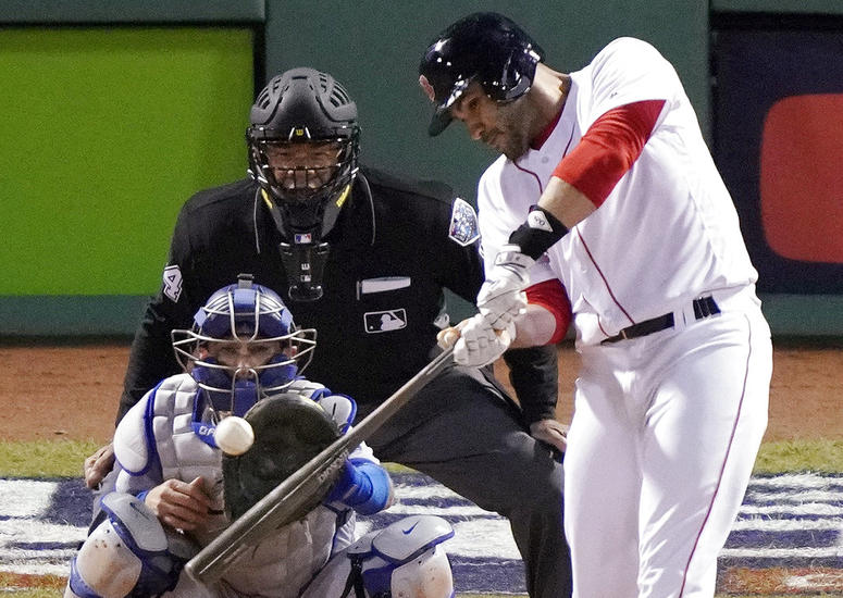 Boston Red Sox designated hitter J.D. Martinez hits a single to drive in two runs against the Los Angeles Dodgers during the fifth inning in Game 2 of the World Series