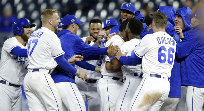 Kansas City Royals mob designated hitter Salvador Perez after he drove in the winning run during the 10th inning