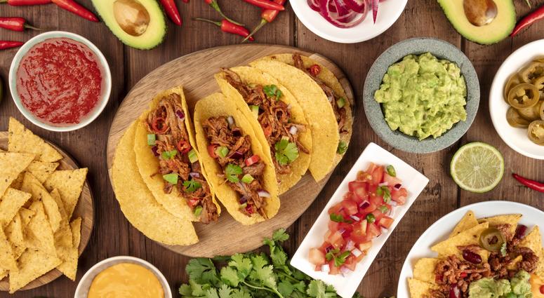 A plate of tacos and condiments