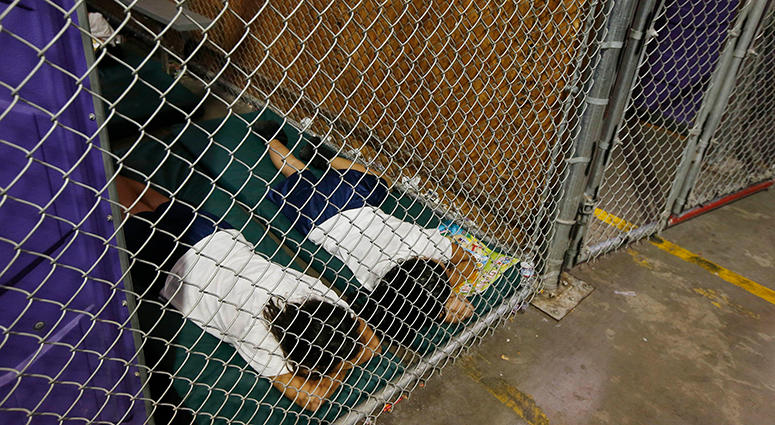 In this June 18, 2014 file photo, two female detainees sleep in a holding cell, as the children are separated by age group and gender, as hundreds of mostly Central American immigrant children are being processed and held at the U.S. Customs and Border Pr In this June 18, 2014 file photo, two female detainees sleep in a holding cell, as the children are separated by age group and gender, as hundreds of mostly Central American immigrant children are being processed and held at the U.S. Customs and Border Pr