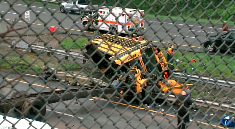 This image taken from WABC-TV video shows an overturned school bus after it collided with a dump truck, injuring multiple people, on Interstate 80 in Mount Olive, N.J. This image taken from WABC-TV video shows an overturned school bus after it collided with a dump truck, injuring multiple people, on Interstate 80 in Mount Olive, N.J.