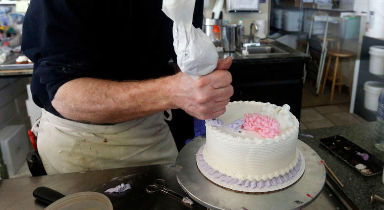 AP FILE - In this March 10, 2014, file photo, Masterpiece Cakeshop owner Jack Phillips decorates a cake inside his store in Lakewood, Colo. AP FILE - In this March 10, 2014, file photo, Masterpiece Cakeshop owner Jack Phillips decorates a cake inside his store in Lakewood, Colo.
