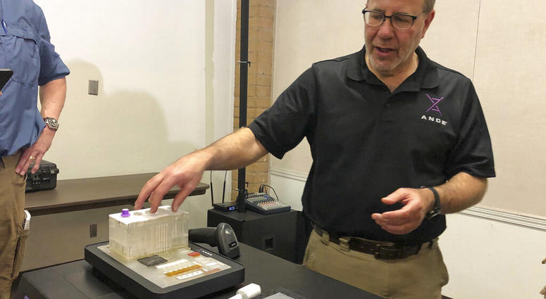 Rapid DNA machine Stephen Meer, chief information officer from ANDE, demonstrates in Chico, Calif., his company's Rapid DNA analysis system.