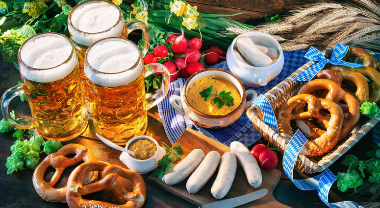 Bavarian sausages with pretzels, sweet mustard and beer mugs Bavarian sausages with pretzels, sweet mustard and beer mugs