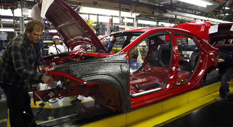 Workers assemble a preproduction Dodge Dart Workers assemble a preproduction Dodge Dart
