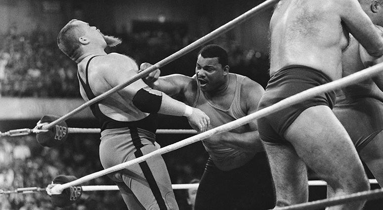 Jim "The Anvil" Neidhart File-This April 7, 1986, file photo shows Chicago Bears' William Perry, right, landing a punch on pro wrestler Jim "The Anvil" Neidhart during the "Over-The-Top-Rope" battle royal at Wrestlemania 2