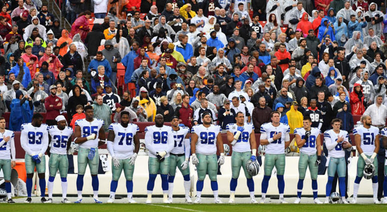 Dallas Cowboys players stand for the national anthem against the Washington Redskins before the game at FedEx Field. Dallas Cowboys players stand for the national anthem against the Washington Redskins before the game at FedEx Field.