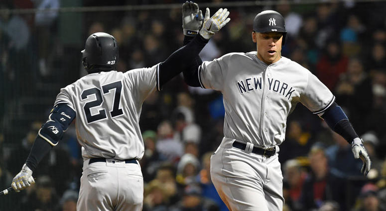 New York Yankees right fielder Aaron Judge (99) reacts with right fielder Giancarlo Stanton (27) after hitting a home run during the fifth inning against the Boston Red Sox at Fenway Park New York Yankees right fielder Aaron Judge (99) reacts with right fielder Giancarlo Stanton (27) after hitting a home run during the fifth inning against the Boston Red Sox at Fenway Park