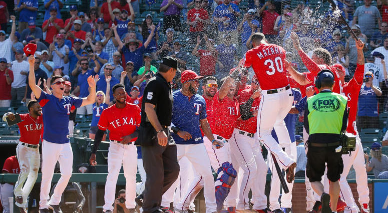 Texas Rangers right fielder Nomar Mazara (30) is greeted at home plate by teammates after hitting a walk off solo homerun in the 10th inning against the Detroit Tigers at Globe Life Park in Arlington Texas Rangers right fielder Nomar Mazara (30) is greeted at home plate by teammates after hitting a walk off solo homerun in the 10th inning against the Detroit Tigers at Globe Life Park in Arlington