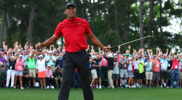 Tiger Woods Tiger Woods celebrates after making a putt on the 18th green to win The Masters golf tournament
