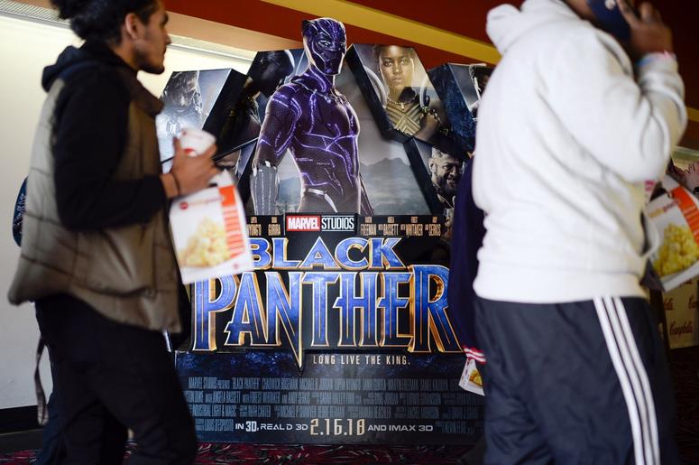 Feb. 15, 2018; Cherry Hill, NJ, USA; Students walk past a 'Black Panther' poster as a special screening is set to begin as part of an event organized by Campbell Soup Company's Black Resource Group at AMC Loews. Mandatory Credit: Joe Lamberti/Courier Post