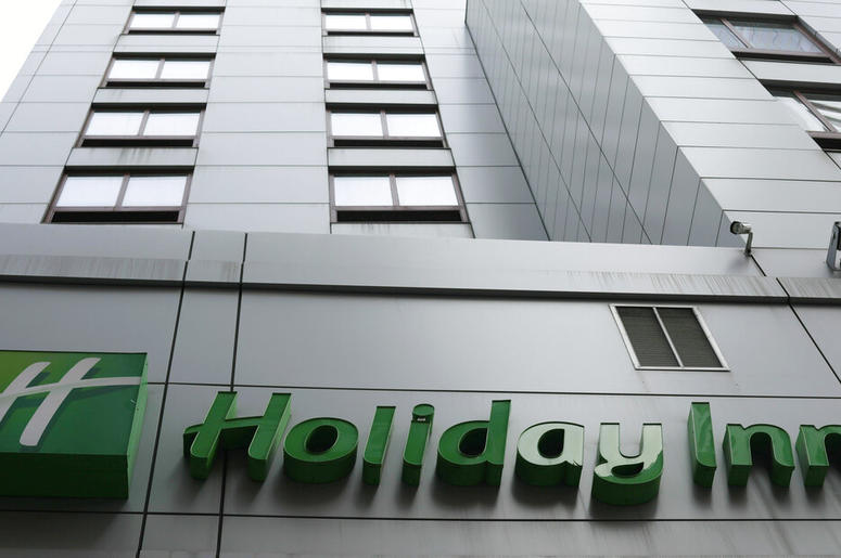 In this file photo dated March 28, 2019, the sign for a Holiday Inn in New York. The fight to save the seas from plastic waste may mean the end for mini bottles of shampoo and other toiletries, after the owner of Holiday Inn and InterContinental Hotels an