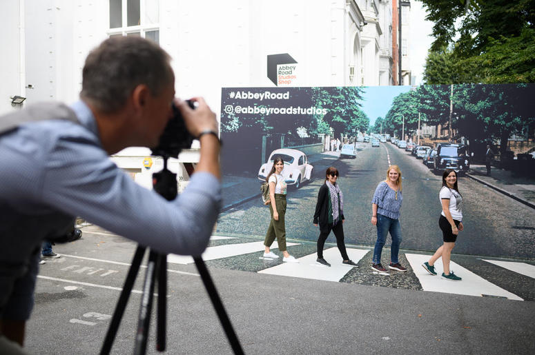 Family Taking Photos Of Abbey Road