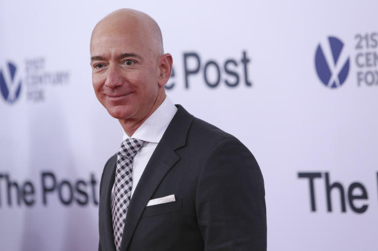 Jeff bezos poses as he arrives on the red carpet for 'The Post' premier at the Newseum Jeff Bezos,Salary,Median,Amazon,10 Seconds,Money,Rich,Executives,CEO,Radio,Employees,ALT 103.7