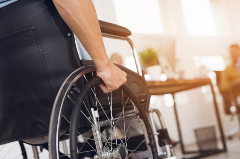 A disabled man is sitting in a wheelchair A disabled man is sitting in a wheelchair