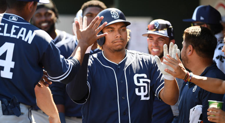 MARCH 18: Josh Naylor #87 of the San Diego Padres celebrates with teammates in the dugout after hitting a solo home run during the second inning of a spring training game against the Cleveland Indians at Goodyear Ballpark on March 18, 2019 in Goodyear, Ar