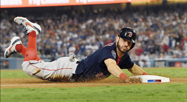 OCTOBER 26: Ian Kinsler #5 of the Boston Red Sox slides in safely to third base against the Angeles Dodgers during the tenth inning in Game Three of the 2018 World Series at Dodger Stadium on October 26, 2018 in Los Angeles, California. (Photo by Harry H