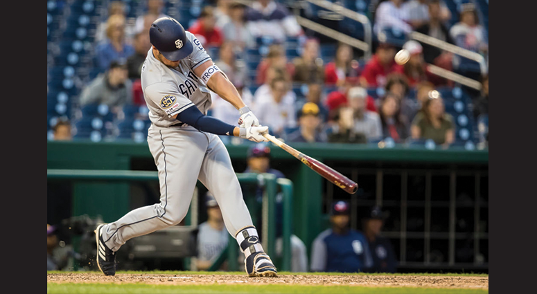 Hunter Renfroe #10 of the San Diego Padres hits a two RBI sacrifice fly against the Washington Nationals during the tenth inning at Nationals Park on April 27, 2019 in Washington, DC. (Photo by Scott Taetsch/Getty Images)