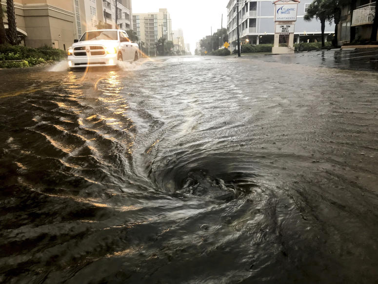 Floodwaters swirl around a storm drain as heavy rain falls from Hurricane Dorian, Thursday, Sept. 5, 2019, in North Myrtle Beach, S.C. Floodwaters swirl around a storm drain as heavy rain falls from Hurricane Dorian, Thursday, Sept. 5, 2019, in North Myrtle Beach, S.C.