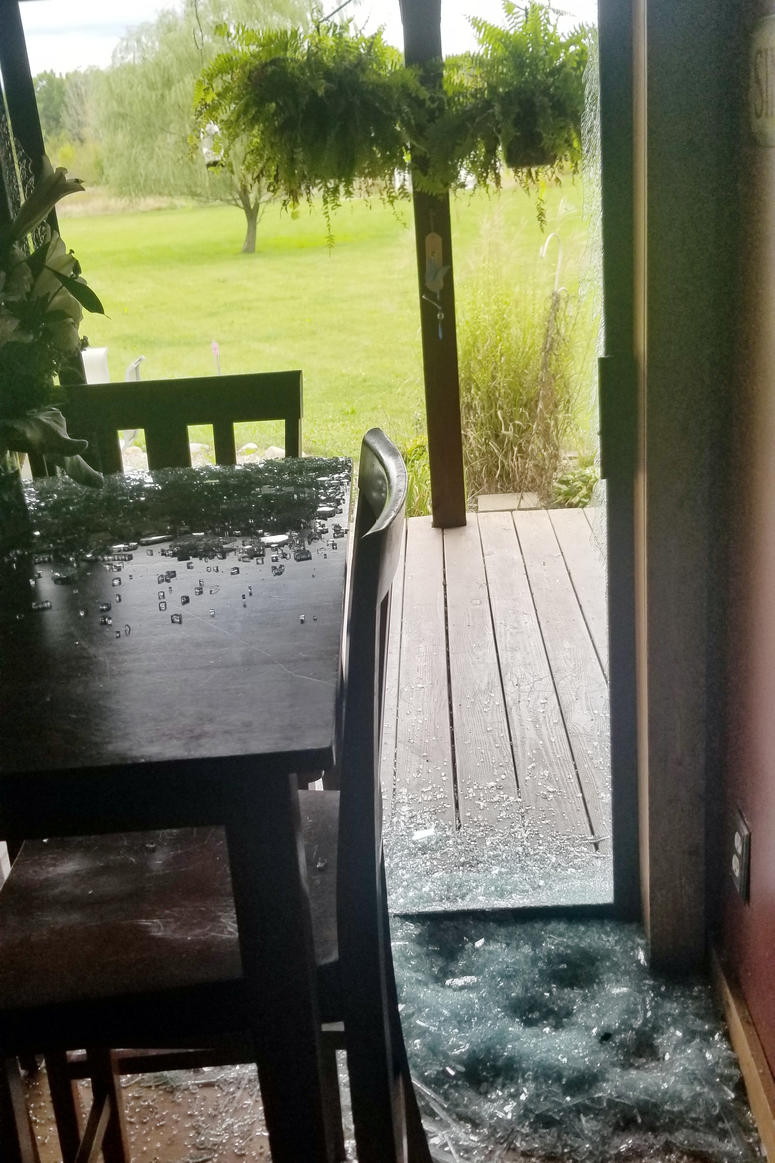 Broken glass from a sliding door is shown at a home in Sullivan Township, Ohio. Broken glass from a sliding door is shown at a home in Sullivan Township, Ohio.