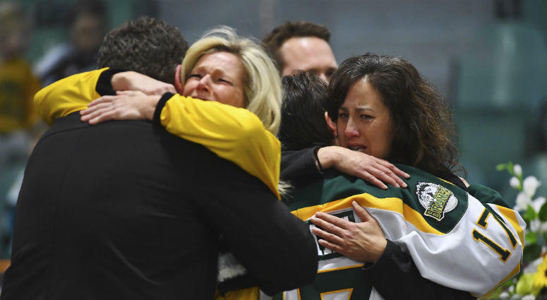 Mourners comfort each other as people attend a vigil at the Elgar Petersen Arena, home of the Humboldt Broncos, to honor the victims of a fatal bus accident in Humboldt, Saskatchewan. Canada Hockey Team Bus Crash