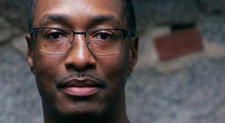 In this Tuesday June 4, 2019 photograph, Sean Ellis poses for a photo at the law office of his attorney Rosemary Scapicchio in Boston. Sean Ellis spent 22 years in prison after a wrongful conviction
