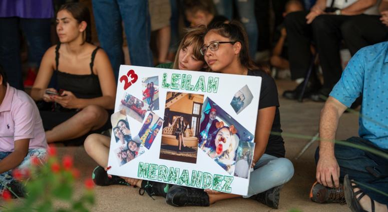 Celeste Lujan, left, and Yasmin Natera hold a sign in honor of Leilah Hernandez during a vigil for victims of the shooting spree the day before, Sunday, Sept. 1, 2019, at the University of Texas of the Permian Basin quad, in Odessa, Texas. Vigil for Odessa, Texas shooting