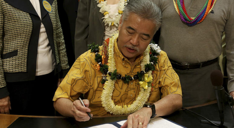 John Radcliffe, right, who was diagnosed with cancer in 2014, watches as Hawaii Gov. David Ige signs a bill to legalize medically assisted suicide on Thursday, April 5, 2018 in Honolulu. John Radcliffe, right, who was diagnosed with cancer in 2014, watches as Hawaii Gov. David Ige signs a bill to legalize medically assisted suicide on Thursday, April 5, 2018 in Honolulu.