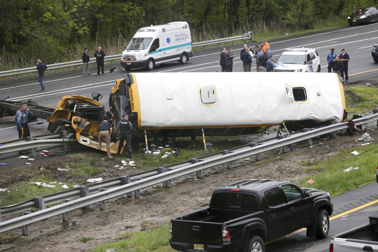 Emergency personnel work at the scene of a school bus and dump truck collision, injuring multiple people, on Interstate 80 in Mount Olive, N.J. Emergency personnel work at the scene of a school bus and dump truck collision, injuring multiple people, on Interstate 80 in Mount Olive, N.J.